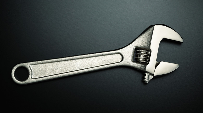 Crescent wrench on black background