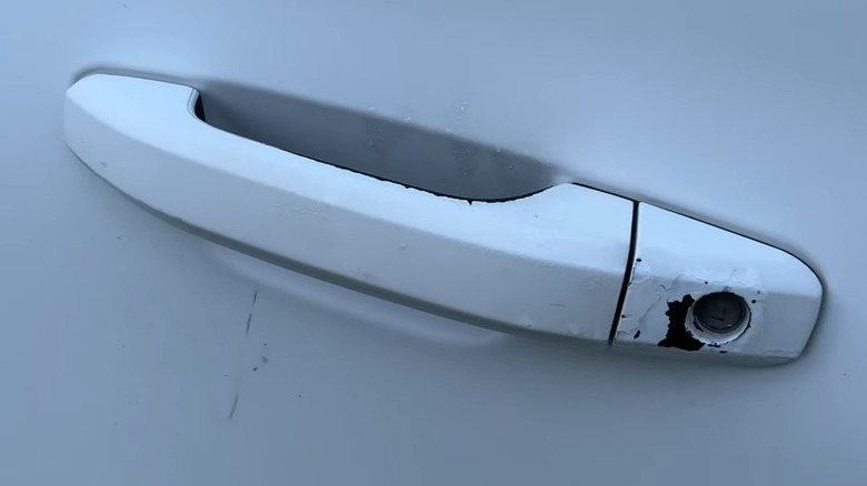 A chipped and worn Chevy Suburban door handle