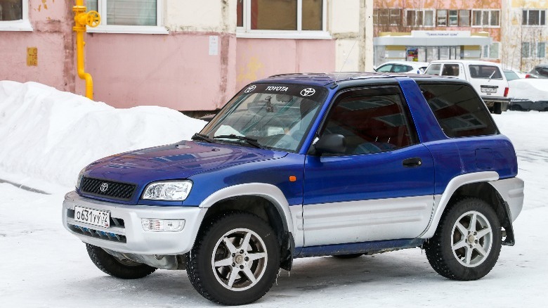 A blue Toyota RAV4 in the snow