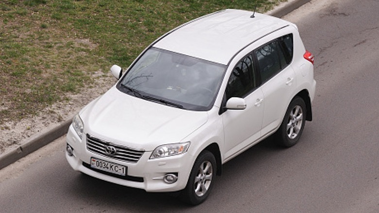 A white RAV4 on the road