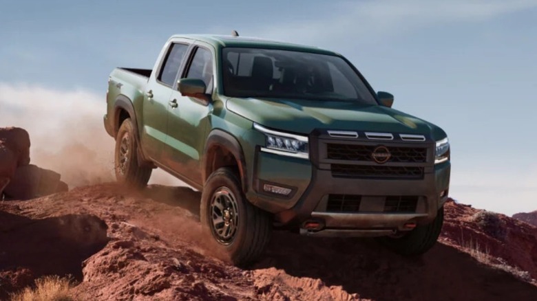 Green Nissan Frontier driving off-road