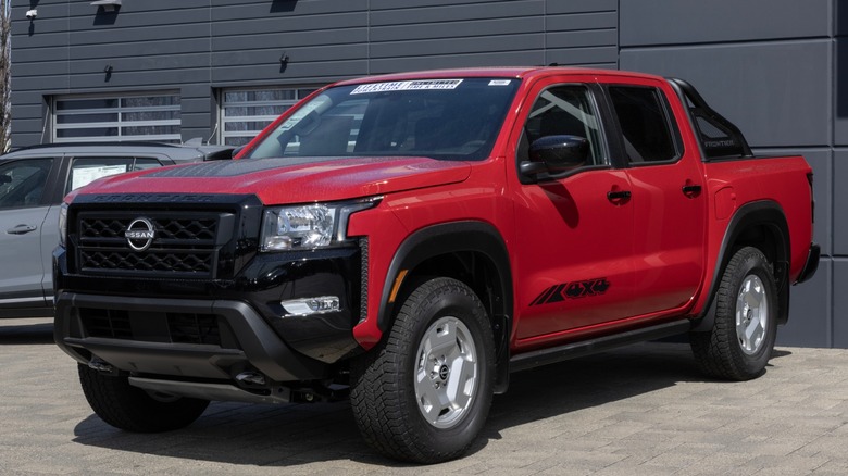 Red Nissan Frontier 4x4 parked in driveway