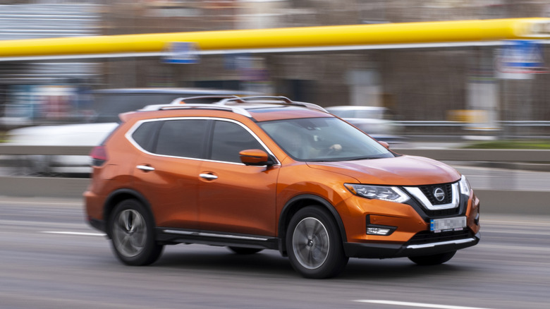 Nissan Rogue racing through city street