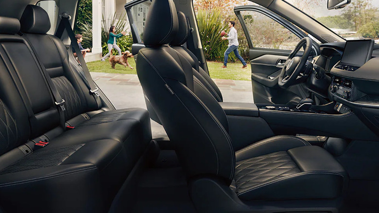 Inside Nissan Rogue seats with family in the background