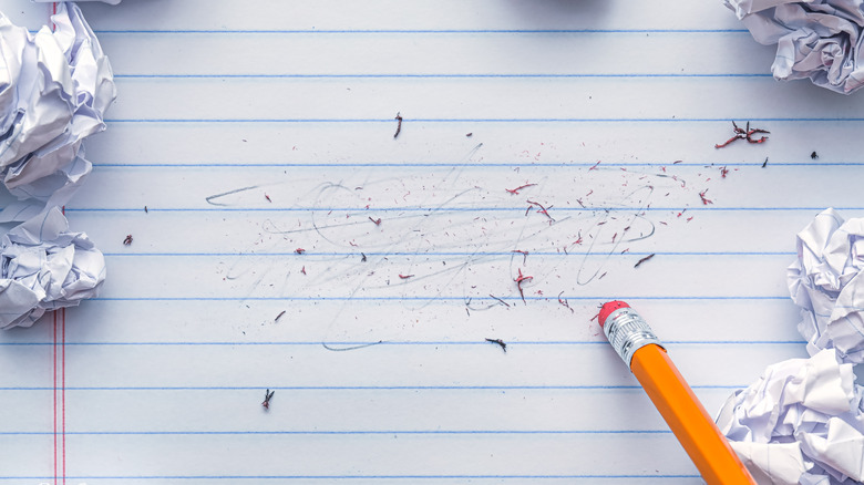 pencil eraser erasing lined paper