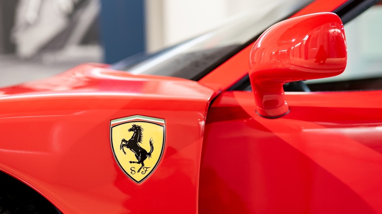 Ferrari logo on red car door