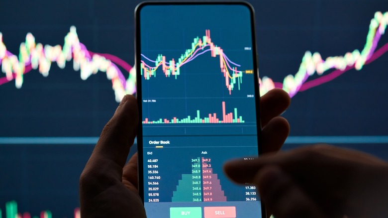 Crypto market graph on smartphone and screen