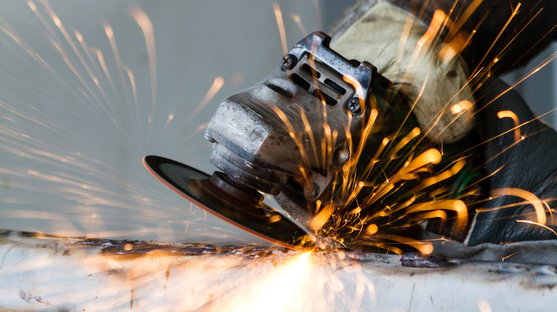 An angle grinder in use with sparks