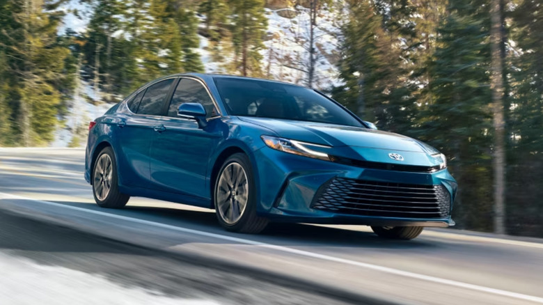 Toyota Camry in ocean gem color on mountain road