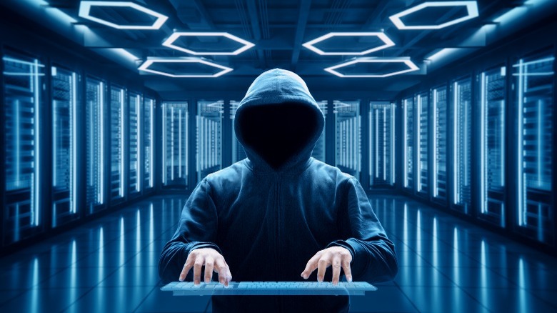 hooded figure keyboard server room