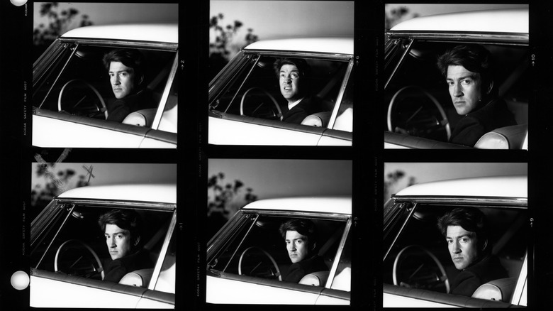 David Lynch sitting in the driver's seat of a car