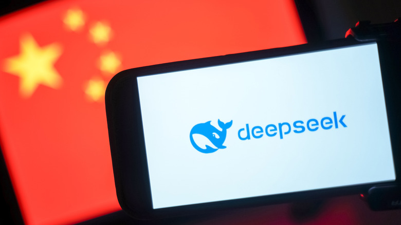 DeepSeek whale logo on a phone in front of a slightly blurred Chinese flag.