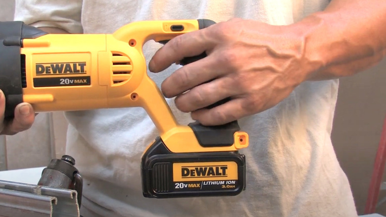 Person holding DeWalt 20v Max powered tool