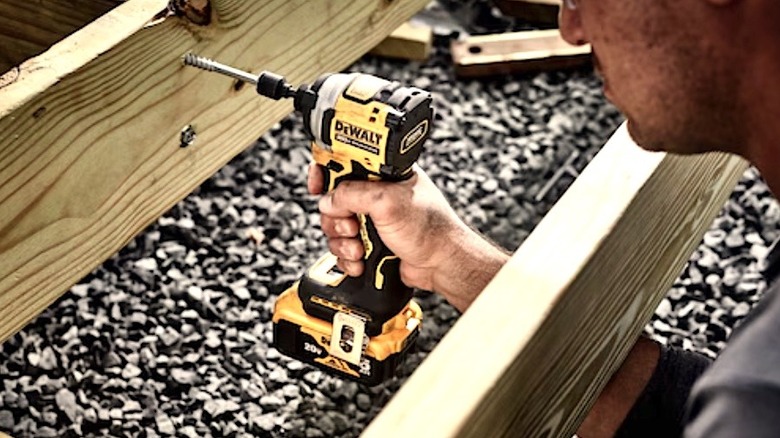 Person using DeWalt Atomic impact driver