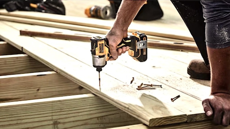 Person using DeWalt Max impact driver