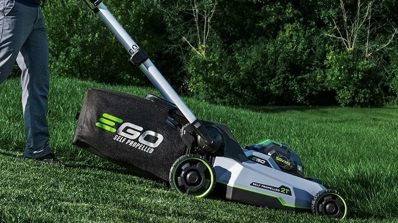 Person cutting grass with Ego mower