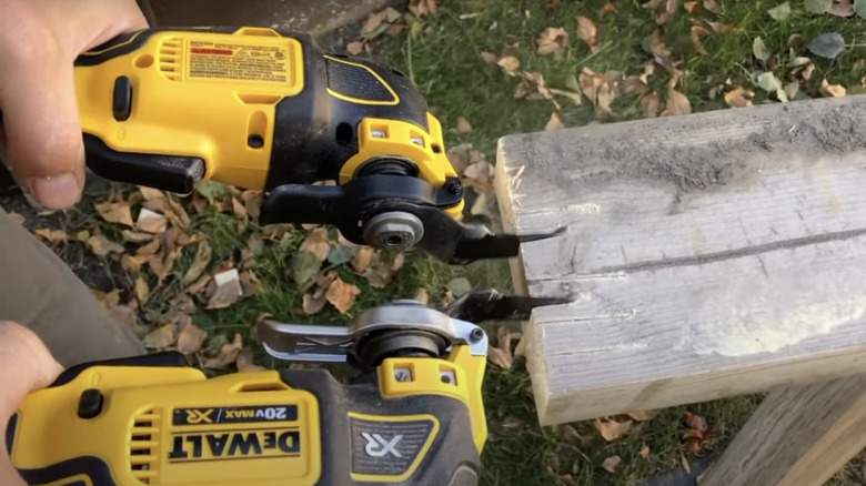 Person comparing two oscillating tool on a piece of wood