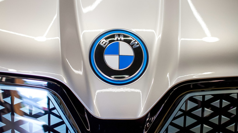 close-up of BMW emblem on hood of car