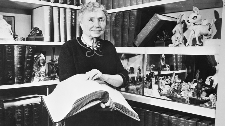 Vintage photo of Helen Keller holding a book