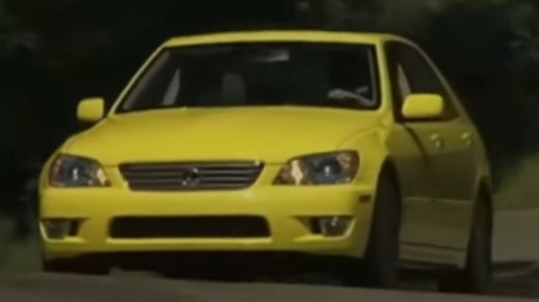 Yellow Lexus IS300 SportsCross driving forward