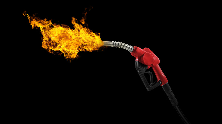 gasoline injector with fire on black background