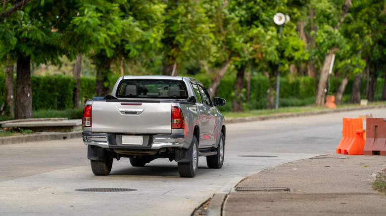 Pickup truck driving down road