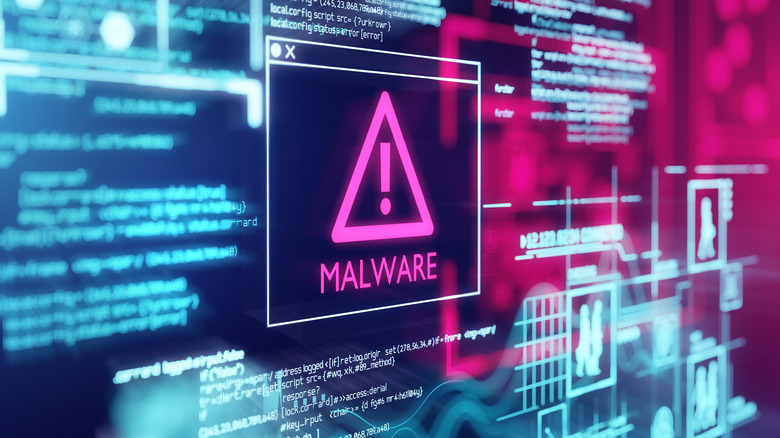 Computer screen with digital graphics and the word malware