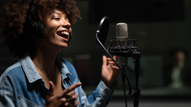 Woman singing into a microphone