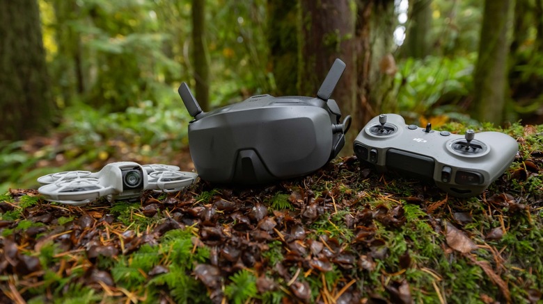 The DJI Goggles N3, DJI Neo, and DJI FPV Controller 3 in the forest.