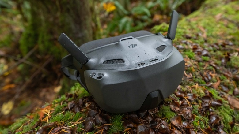 DJI Goggles N3 sitting on a mossy log.