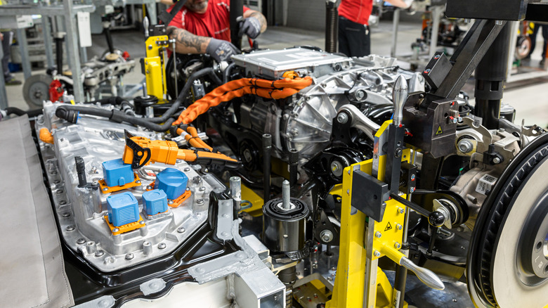 Mechanic working on Porsche electric motor