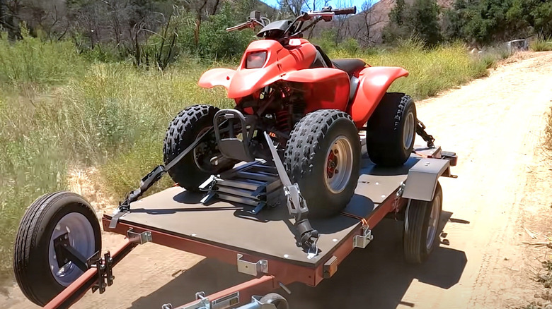 ATV parked and strapped onto a Harbor Freight trailer