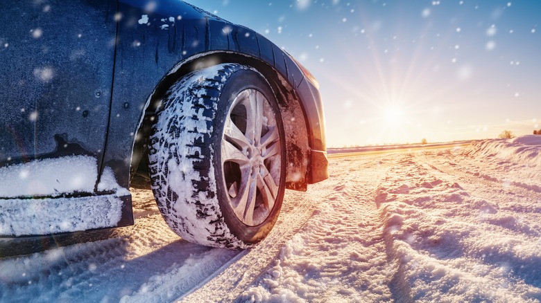 Car driving on snowy trail