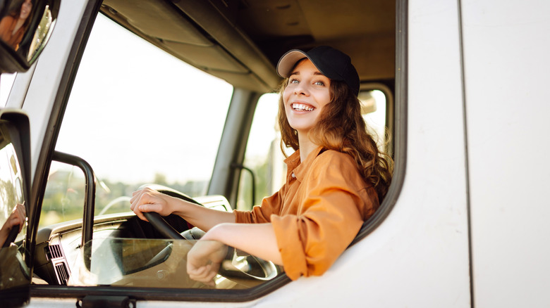 Woman looking out open truck window