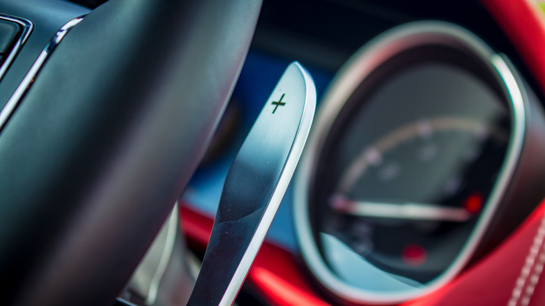 close up of metal paddle shifter on a car