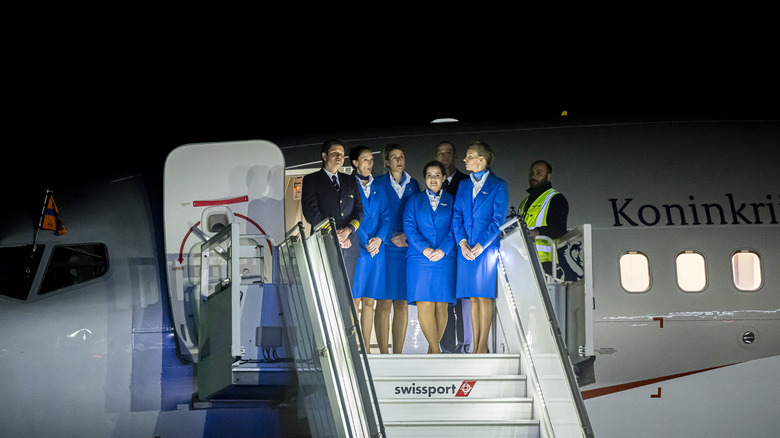 Airline crew standing on plane steps