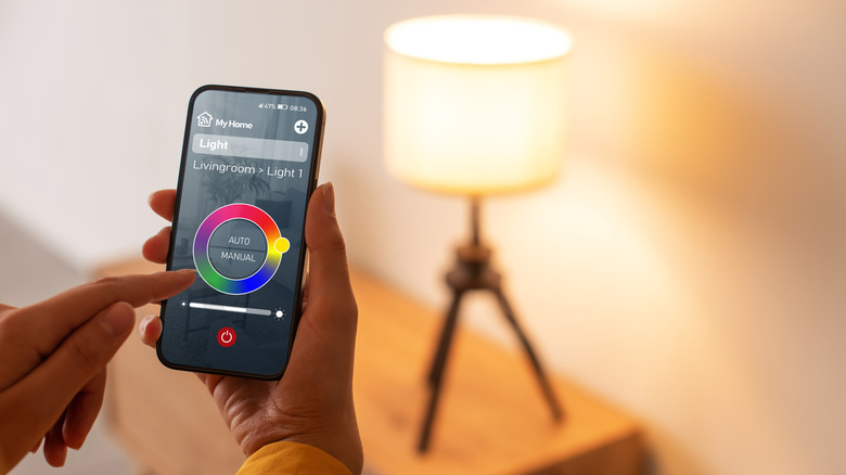 Woman using app to control smart light