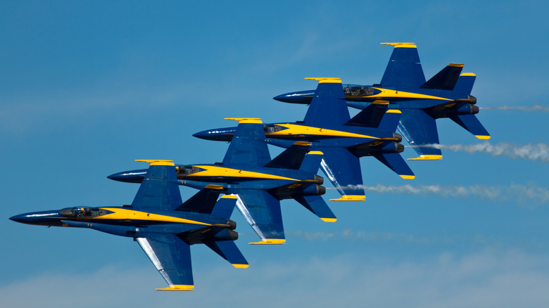 The Blue Angels flying in close proximity to one another.