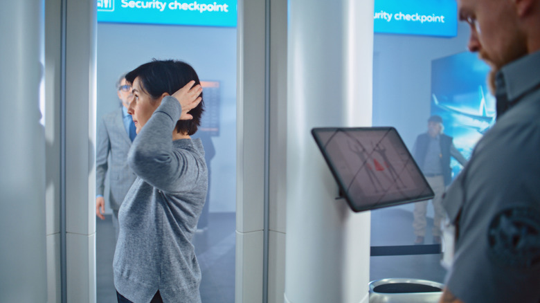 woman getting full body scan at airport security