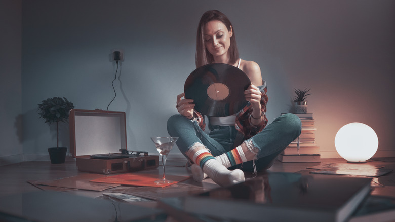 woman appreciating vinyl records