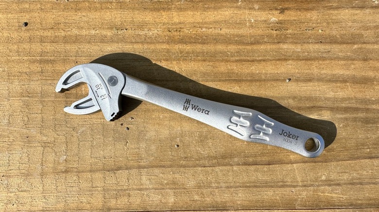 A self setting wrench on a piece of wood