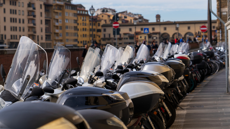 parked mopeds on packed city street