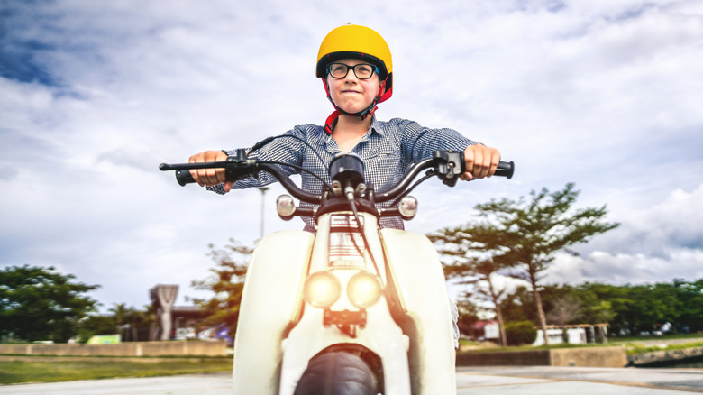 kid riding a moped