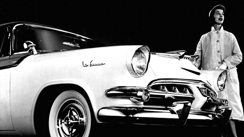 Woman models alongside the Dodge1955 La Femme front end