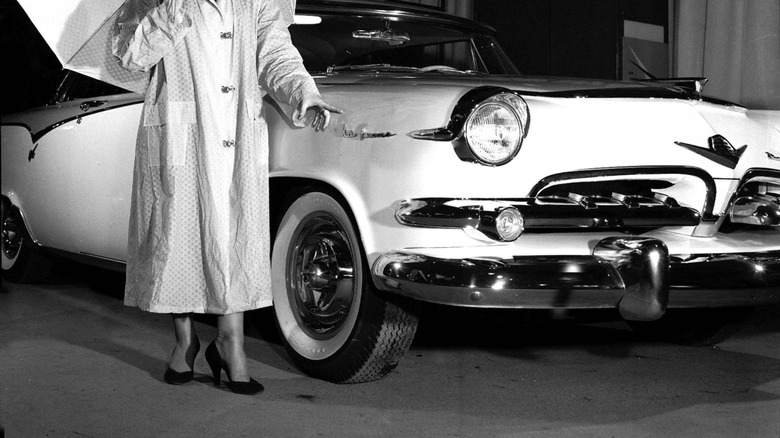 Woman models next to the Dodge La Femme with matching outfit