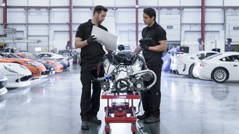 Engineers looking over an engine