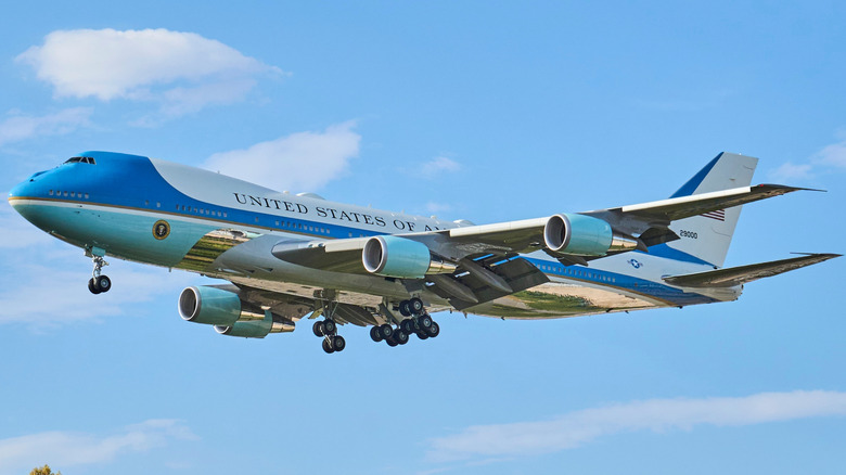 Air Force One flying against a blue sky.