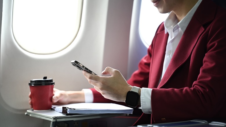 Person talking on the phone on an airplane