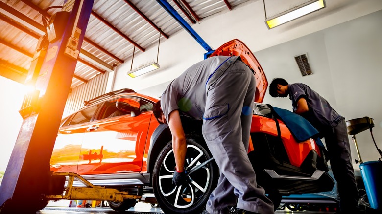 mechanics working on a car