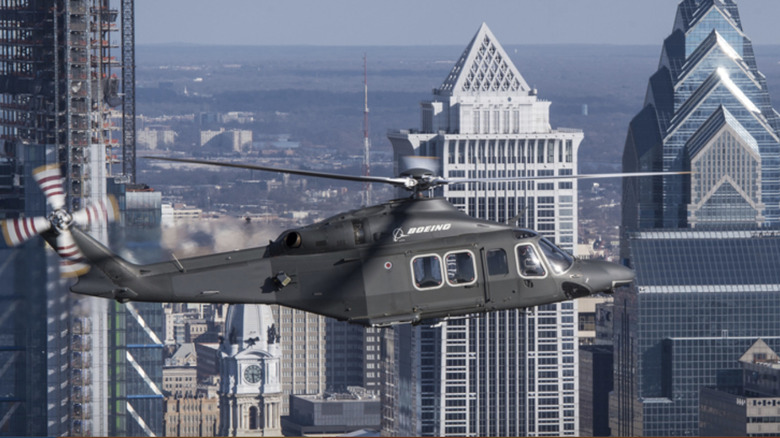 MH-139A Grey Wolf flying over city skyscrapers